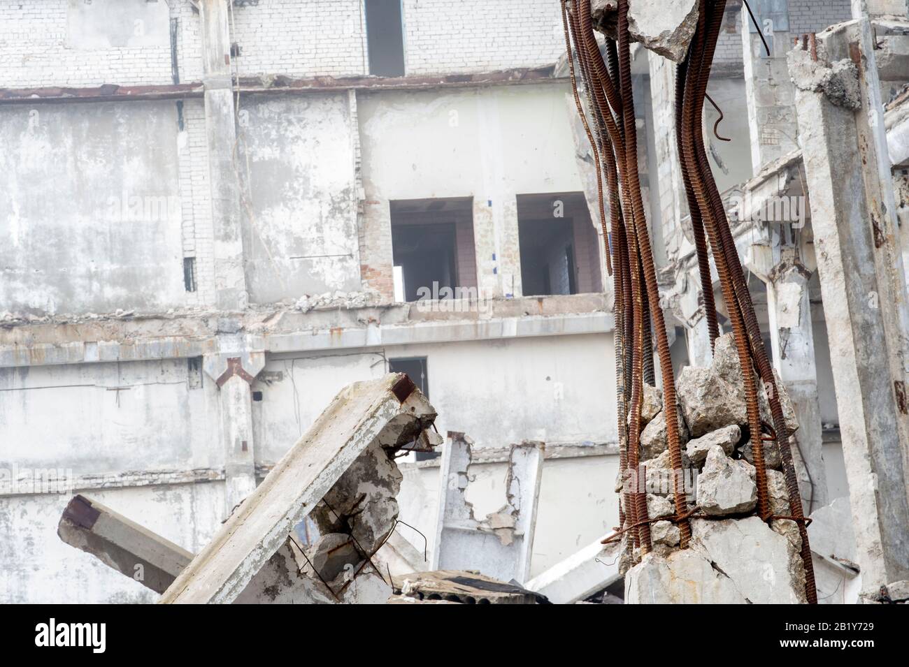The remains of a large building destroyed in a foggy haze. Concrete ...
