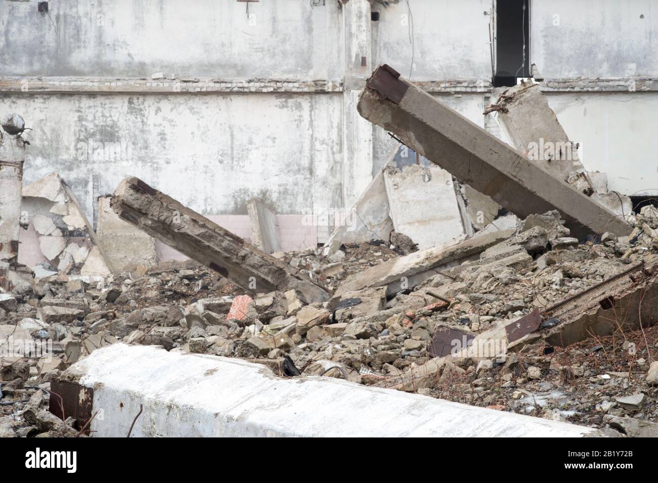 The remains of a large building destroyed in a foggy haze. Concrete ...