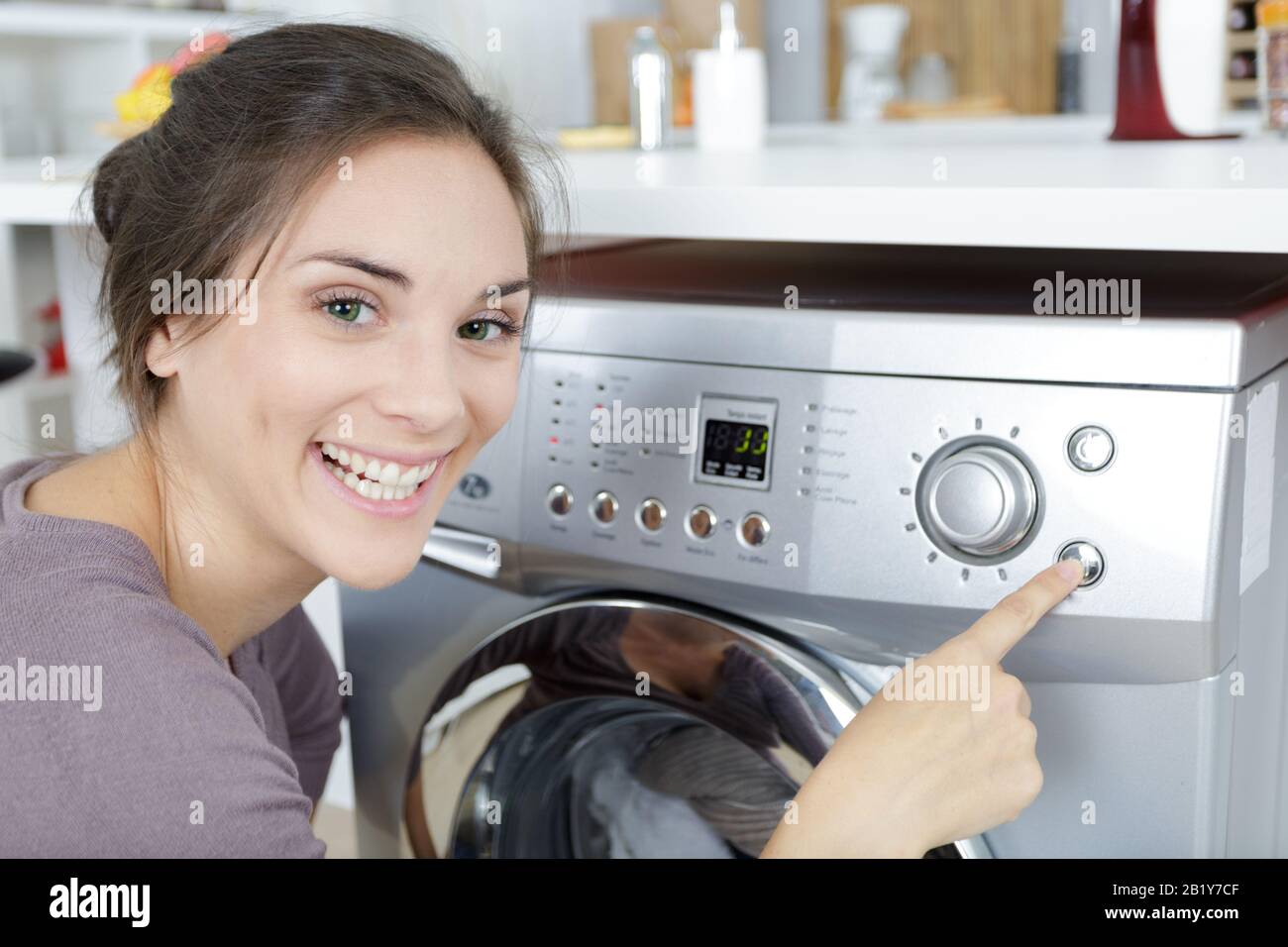 Woman Loading Dirty Clothes In Washing Machine Stock Photo Alamy