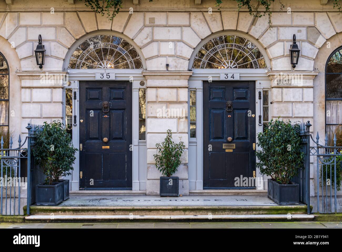 Fitzroy Square London. Doorways of number 34 and 35 Fitzroy Square Fitzrovia London. Called Swiss House from 1936. Owned by film director Guy Ritchie. Stock Photo