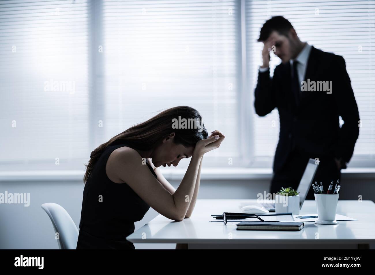 Team Of Unhappy Businesspeople Sitting In Business Meeting Stock Photo