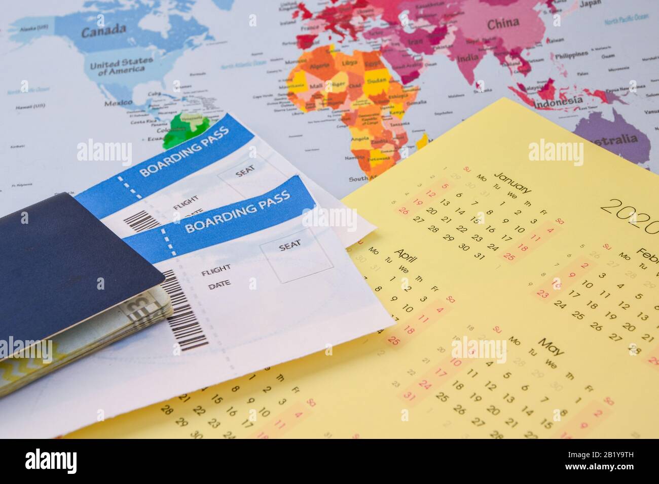 passport, boarding pass over map. travel concept., on calendar with pins Passport on map ticket, planning trip Stock Photo