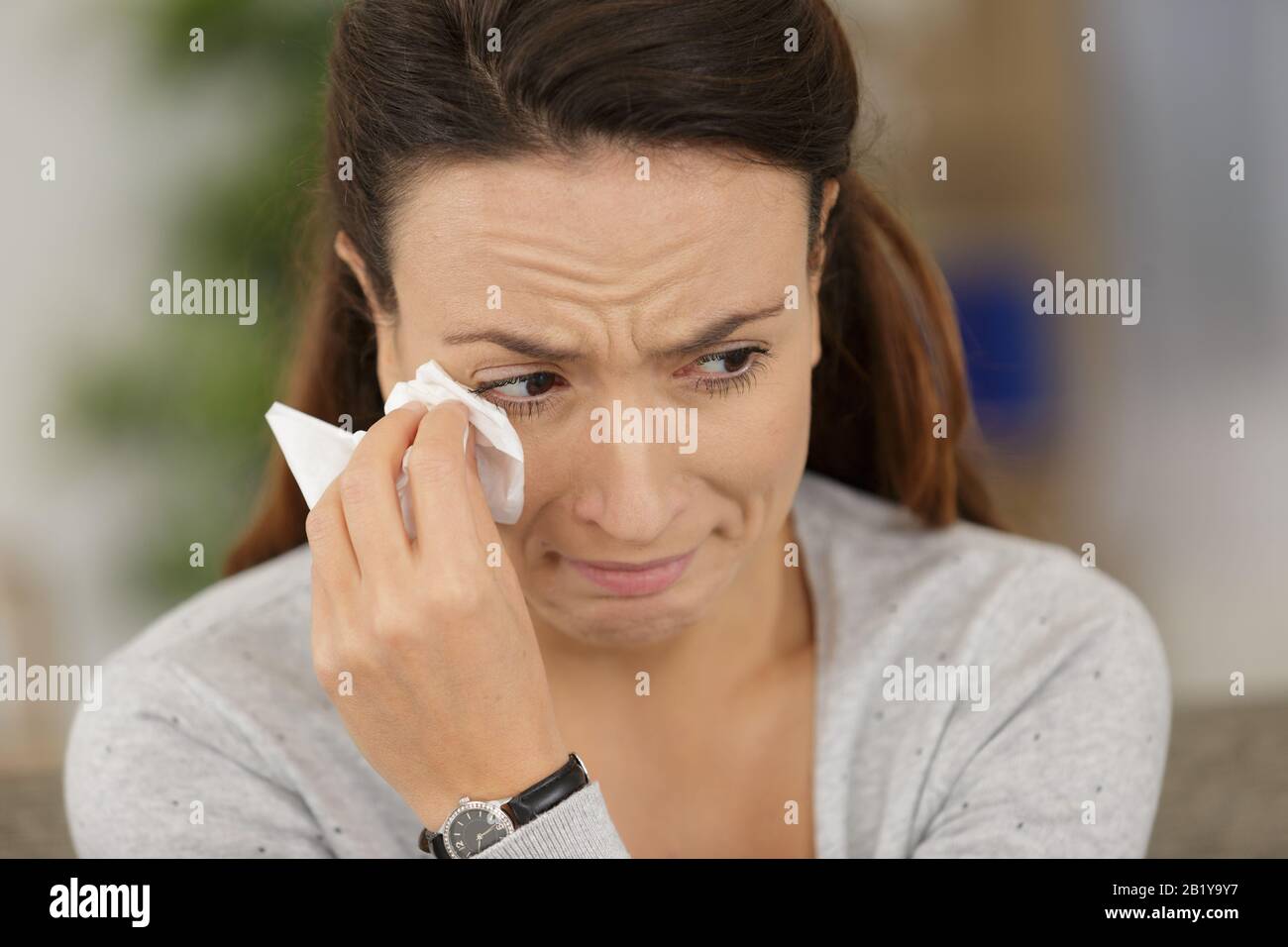 portrait of pensive crying woman on the sofa Stock Photo - Alamy