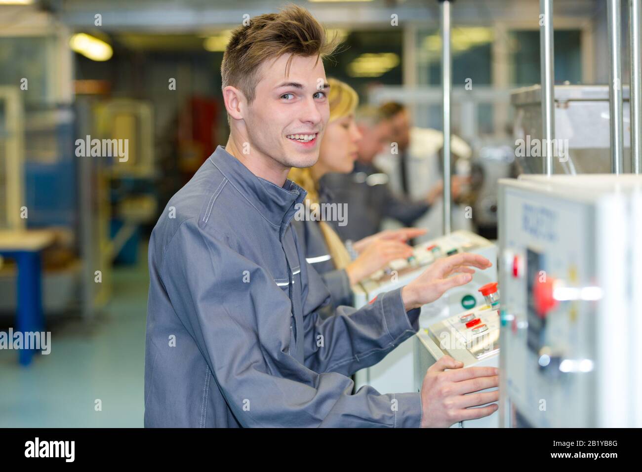 industrial young machine controller smiling Stock Photo Alamy