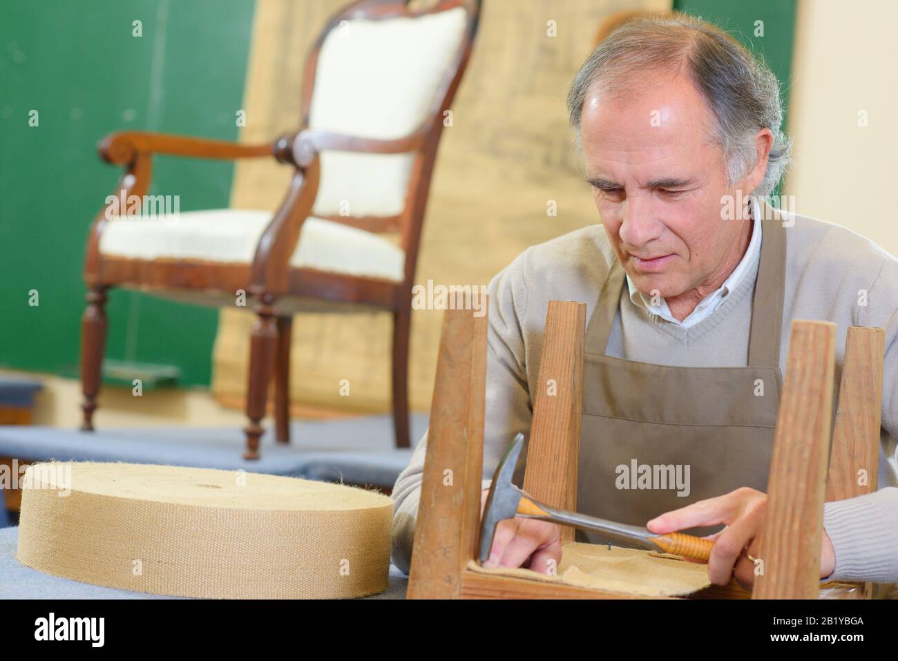 a man is fixing a chair Stock Photo Alamy