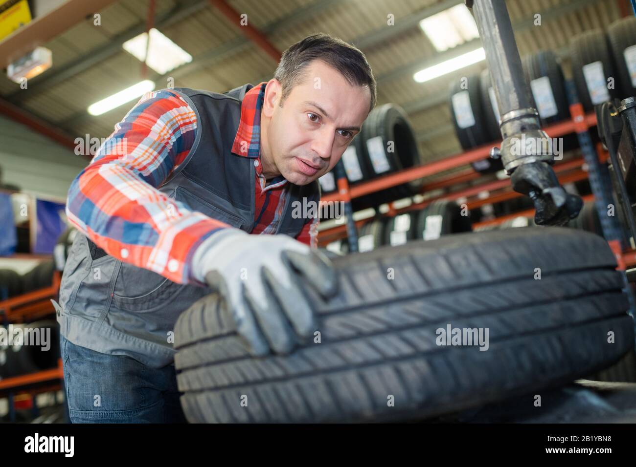 garage man working with tyres Stock Photo