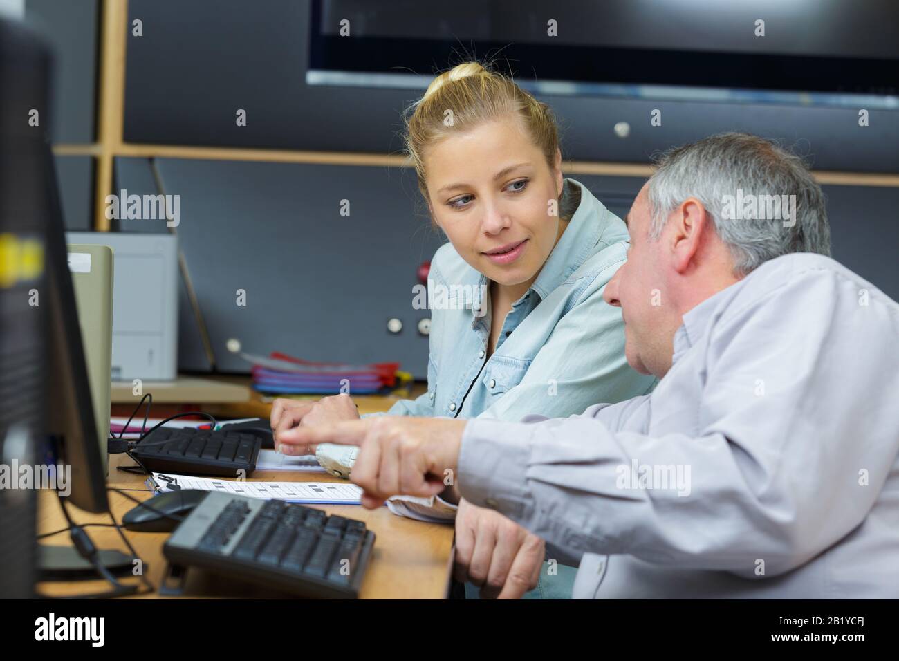Helping coworker office hi-res stock photography and images - Alamy