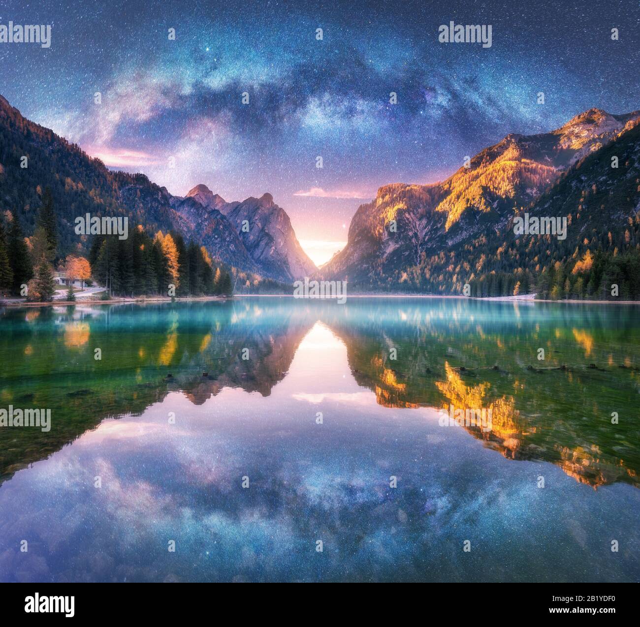 Milky Way reflected in water in mountain lake at starry night Stock Photo