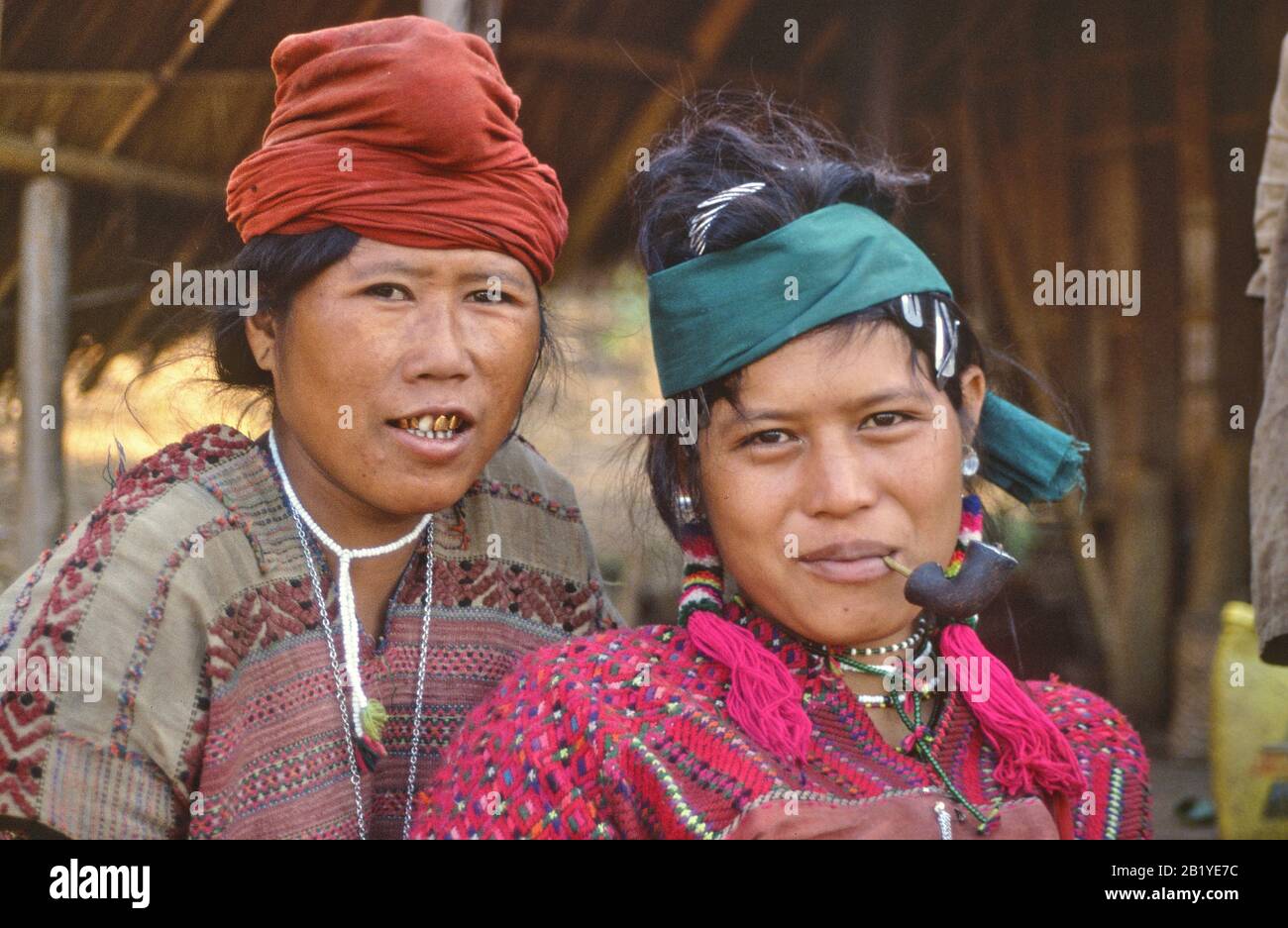 Women from Pwo Karen tribe in Northern Thailand, one of them smoking a pipe. Stock Photo