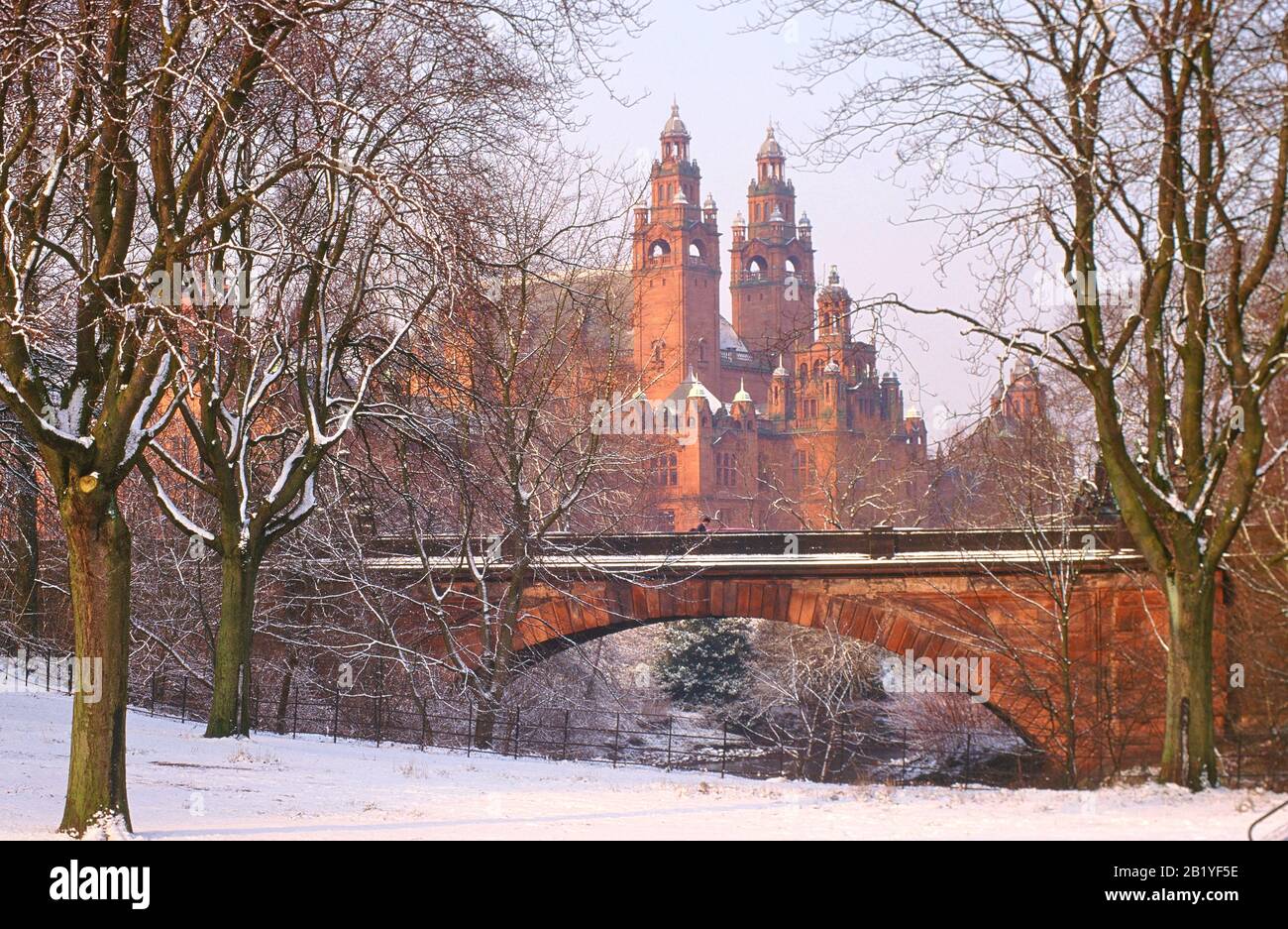 Snow covered Kelvingrove Park, Glasgow with Kelvingrove Art Gallery and Museum in background. Stock Photo