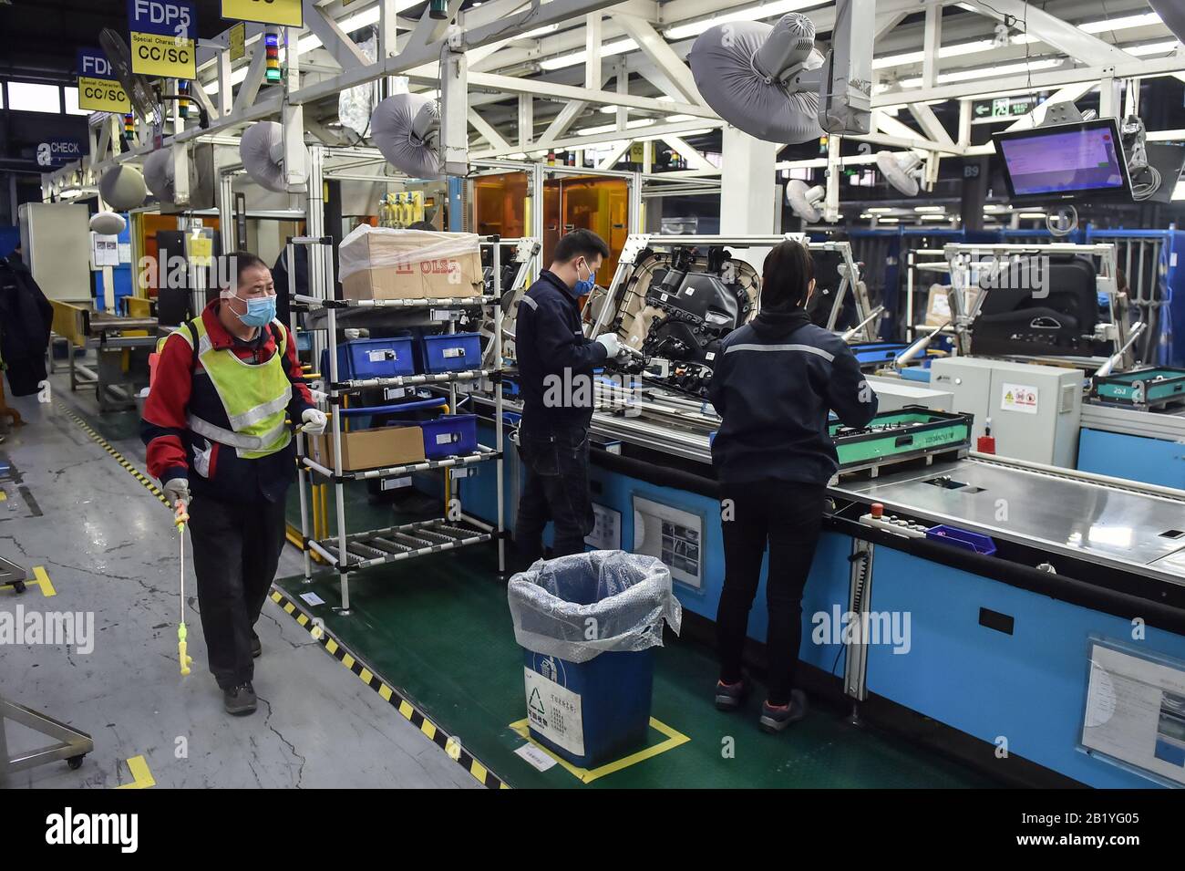 Beijing, China. 12th Feb, 2020. A worker disinfects the assembly line in a workshop of an automotive company in Beijing, capital of China, Feb. 12, 2020. Credit: Peng Ziyang/Xinhua/Alamy Live News Stock Photo