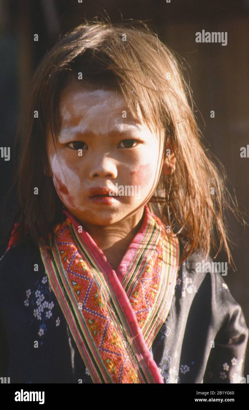 Young girl of Hmong / Miao Tribe in Northern Myanmar wearing traditional dress and face painted