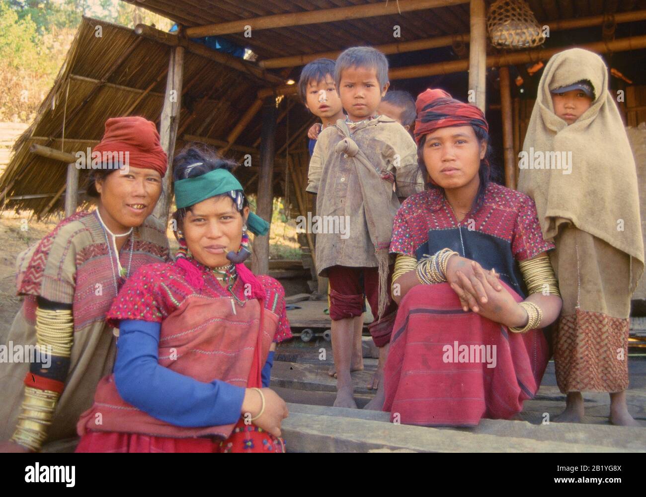 Women and kids from Pwo Karen in Northern Thailand, one of them smoking a pipe. Stock Photo