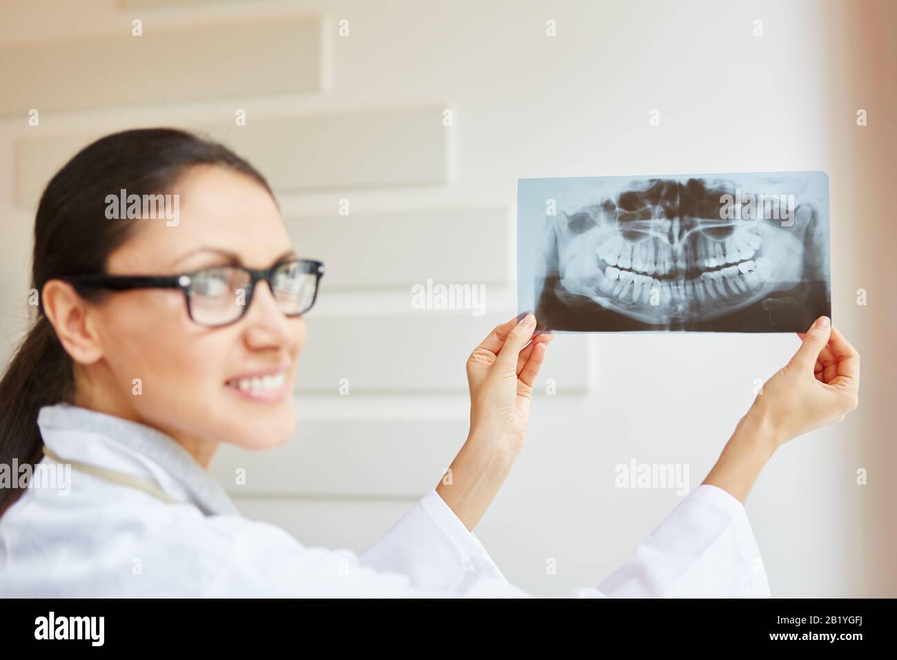 Woman as a dentist with xray image in her hands Stock Photo Alamy
