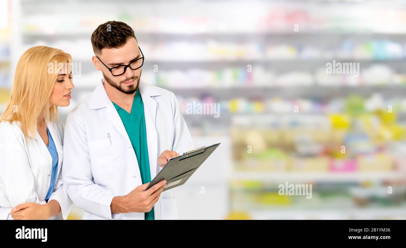 Pharmacist working with another pharmacist in the pharmacy. Healthcare