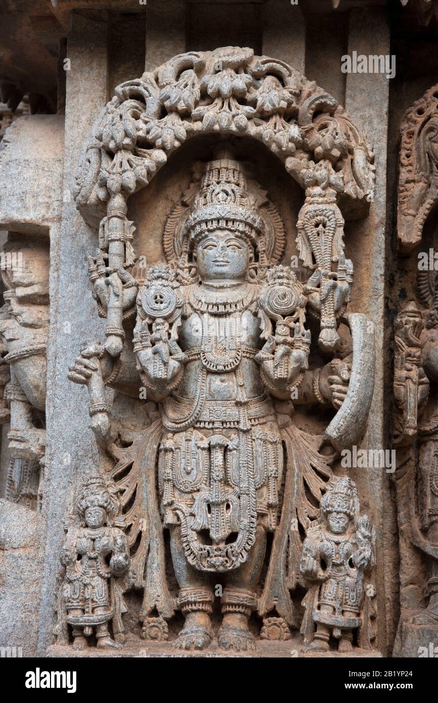 Carved Lord Vishnu idol on the outer wall of the Chennakesava Temple, Somanathapura, Karnataka, India Stock Photo