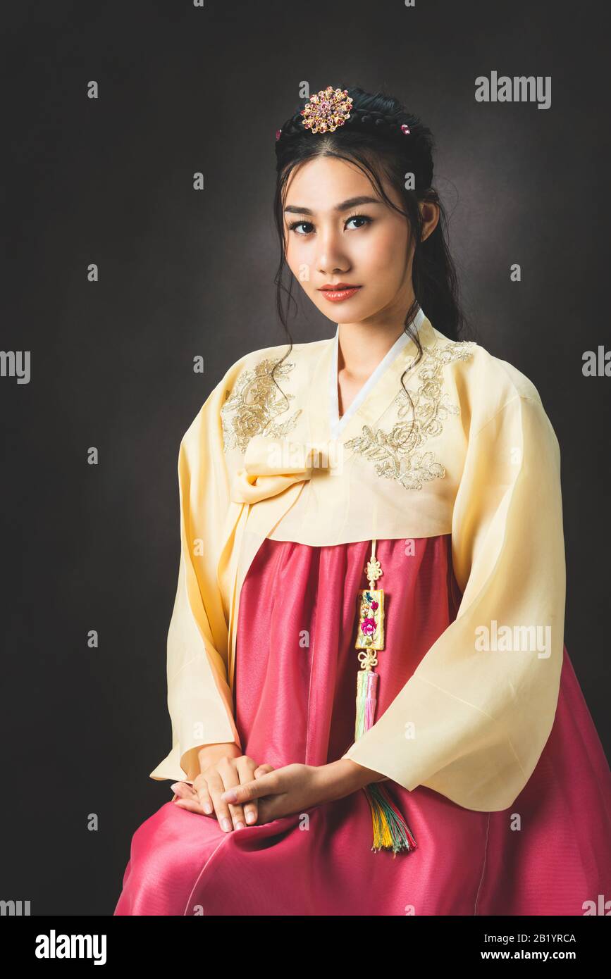 Korean woman wearing traditional korean dress (Hanbok) on black