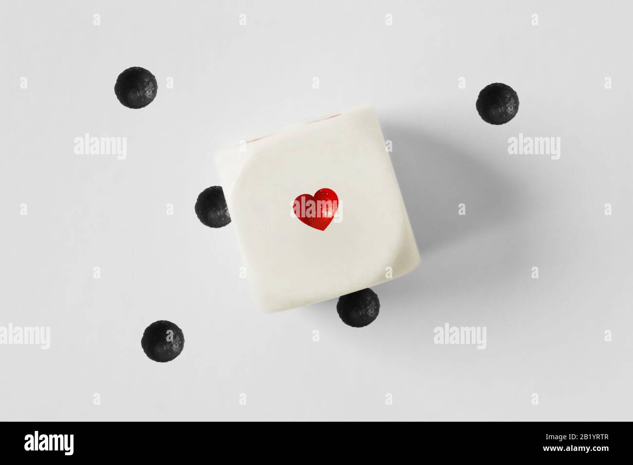 Dice with heart and lost black dots on white background Stock Photo