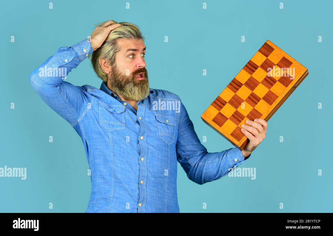 oh my god. intelligence quotient concept. human brain working. brainstorming concept. play chess tournament. Intelligence level measurement. level up your iq. surprised bearded man hold chess board. Stock Photo