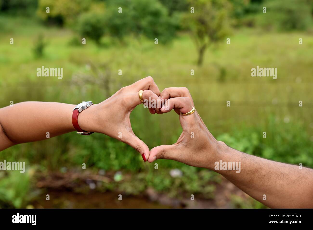 Heart shape formed by a female and male hand joined together, Pune, Maharashtra, India Stock Photo
