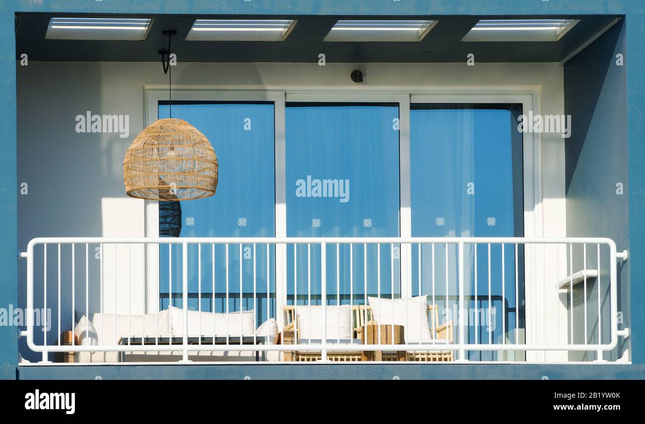 Balcony with a table, sofa and chairs Stock Photo - Alamy