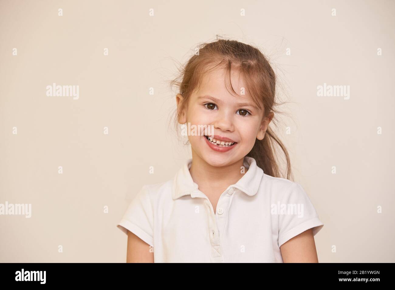 Young beauty girl portrait. Look at camera. Neutral background Stock Photo