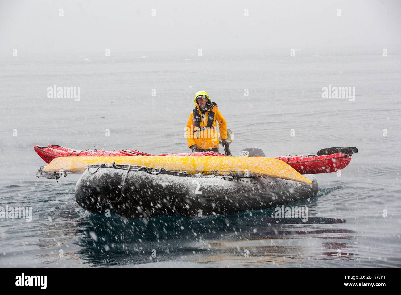 Zodiacs from an expedition cruise ship in heavy snow in Fournier Bay, Antarctica. Stock Photo