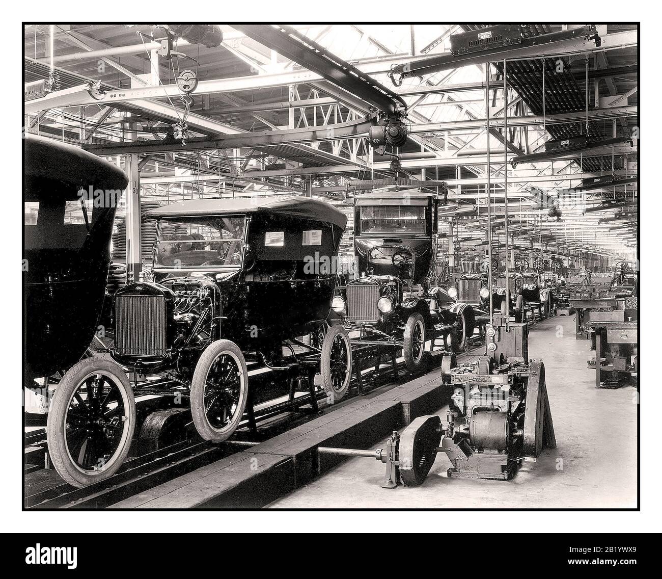 Archive 1900’s Ford Company Model T motorcar assembly line The creation of the moving assembly line by Henry Ford at his Highland Park plant, introduced on December 1, 1913, revolutionized the automobile industry and the concept of manufacturing worldwide.  Sheer production of the Model T dramatically increased. The production time for a single car dropped from over 12 hours to just 93 minutes due to the introduction of the assembly line. Ford’s 1914 production rate of 308,162 eclipsed the number of cars produced by all other automobile manufacturers combined. Detroit Michigan USA Stock Photo