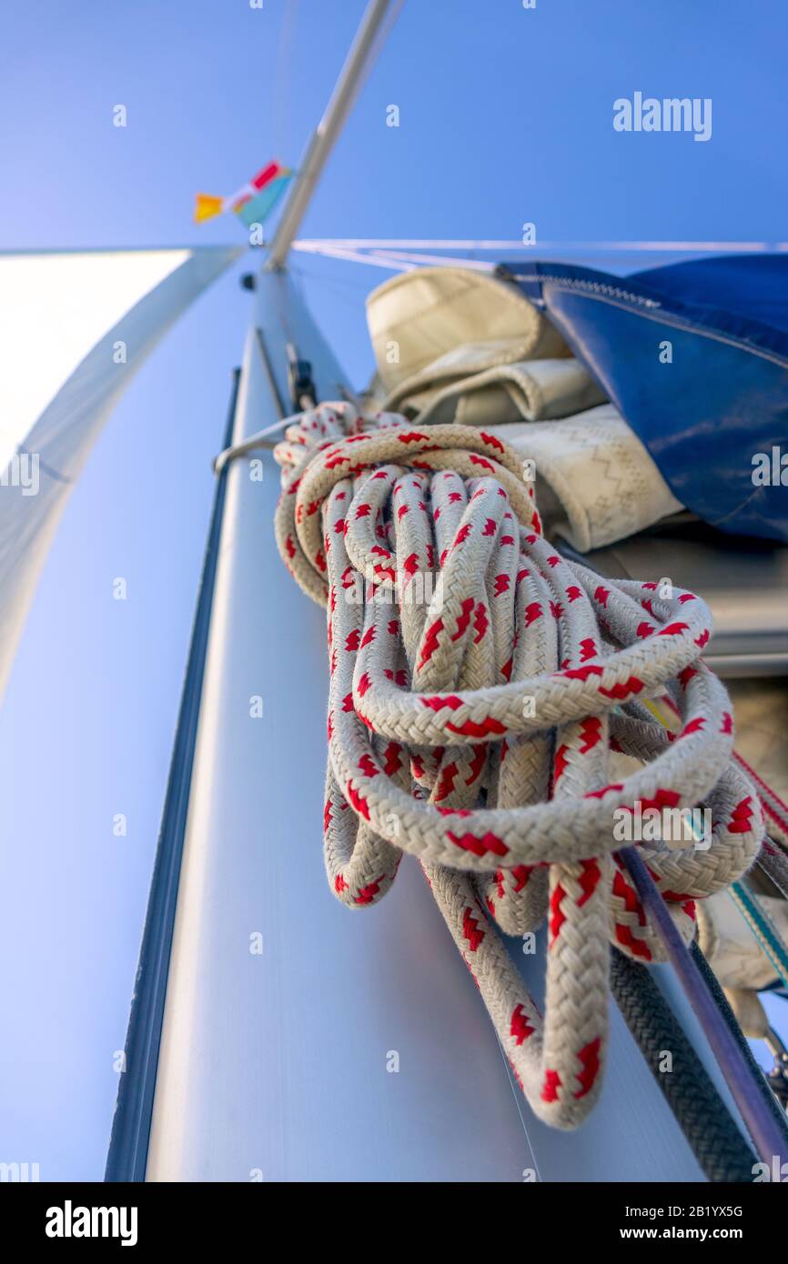 Bottom view of the mast of a sailing yacht. A hank of rope and other rigging, Blue sky Stock Photo