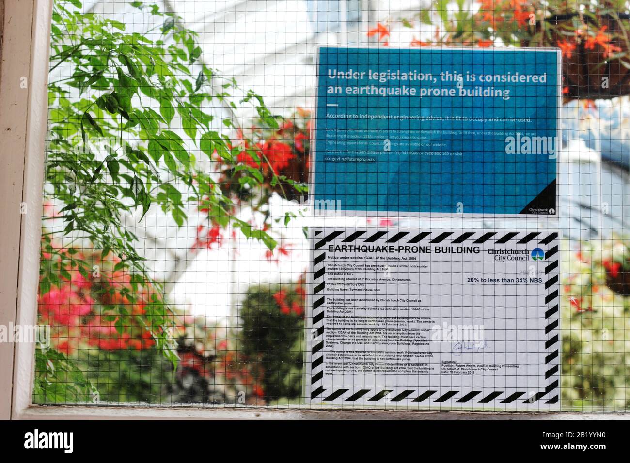 Some New Zealand buildings carry earthquake warning signs, like this