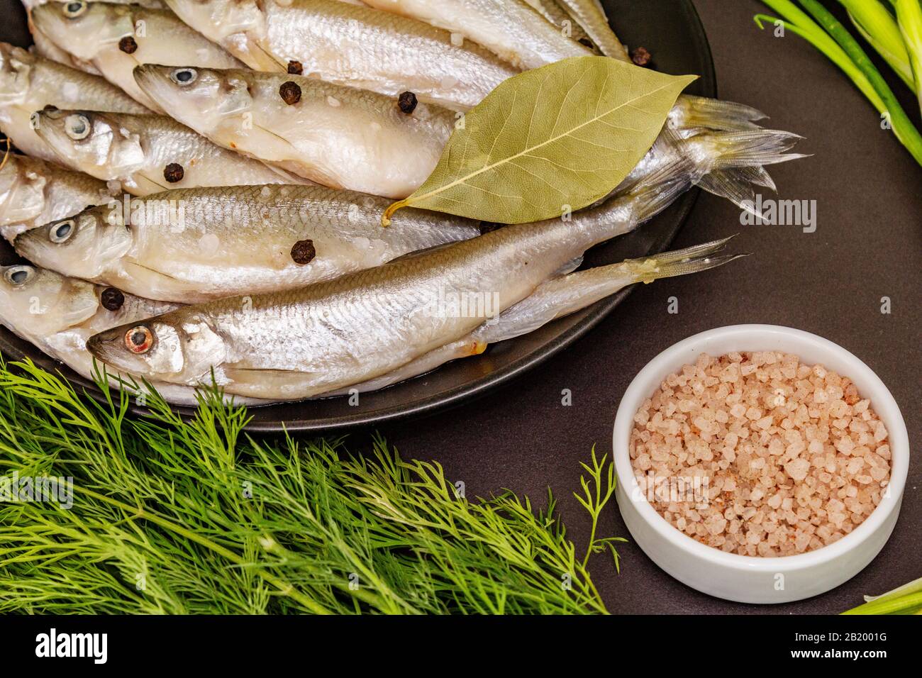 Raw sea fish smelt, sardines, anchovies, capelin with the scent of fresh cucumber ready for