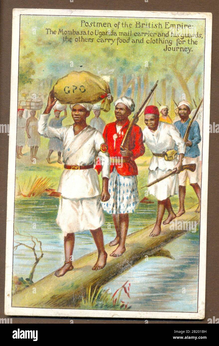 Picture postcard from series Postmen of the British Empire.    The Mombasa to Uganda mail carrier and his guards, the others carry food and clothing for the Journey.    1906 Stock Photo