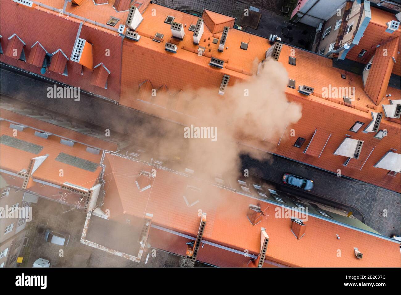 Smoke from chimney polluting air and causing smog, surroundings of old market in Poznan Stock Photo