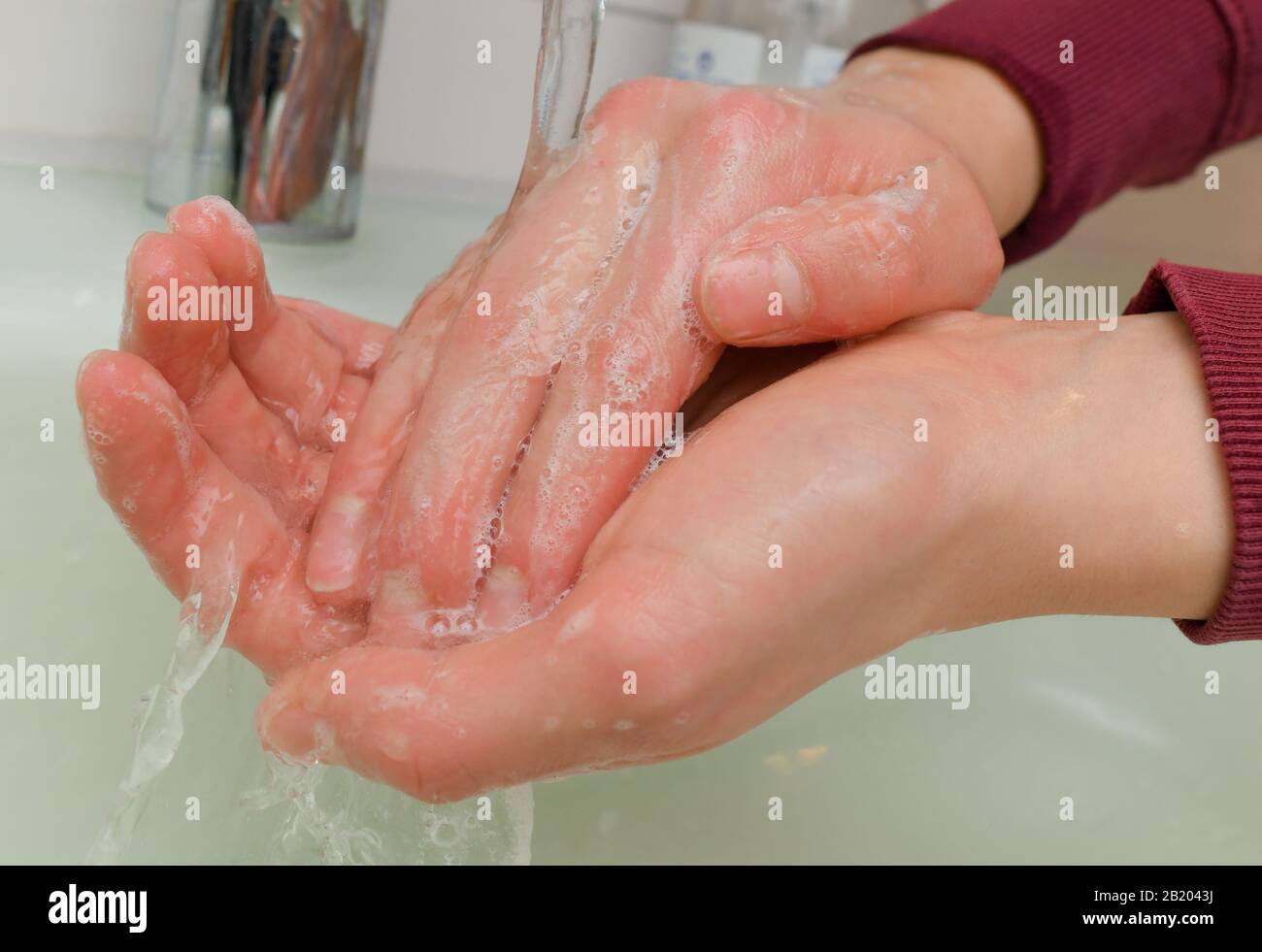 Sieversdorf, Germany. 27th Feb, 2020. A girl washes her hands with soap and water (posed photo). Hand hygiene measures are among the most important infection prevention measures. Personal hygiene, especially thorough hand Sieversdorf, Germany. 27th Feb, 2020. A girl washes her hands with soap and water (posed photo). Hand hygiene measures are among the most important infection prevention measures. Personal hygiene, especially thorough hand