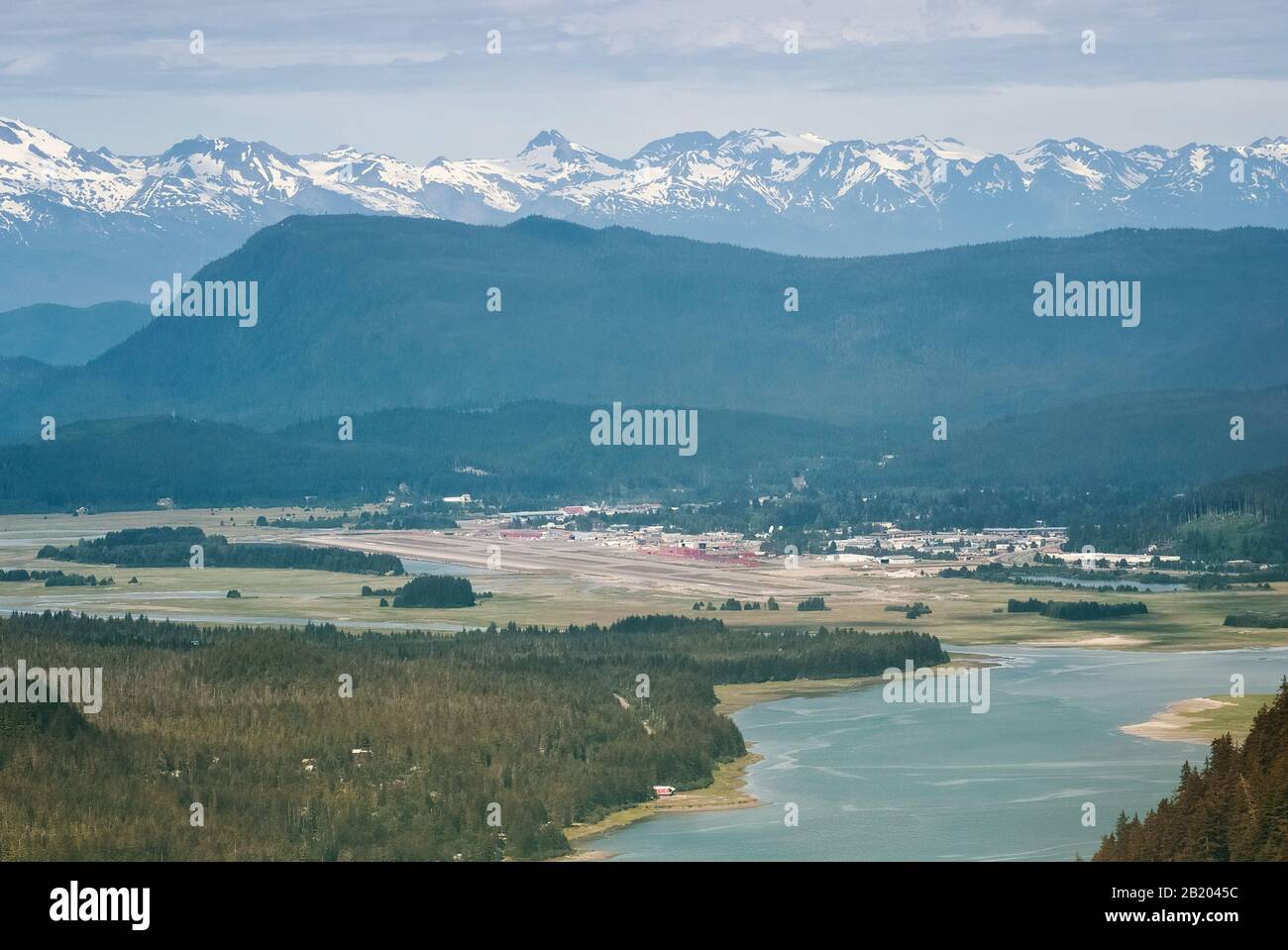 Aerial View Of Snow Capped Mountain Range Surrounding Juneau, AK Stock Photo