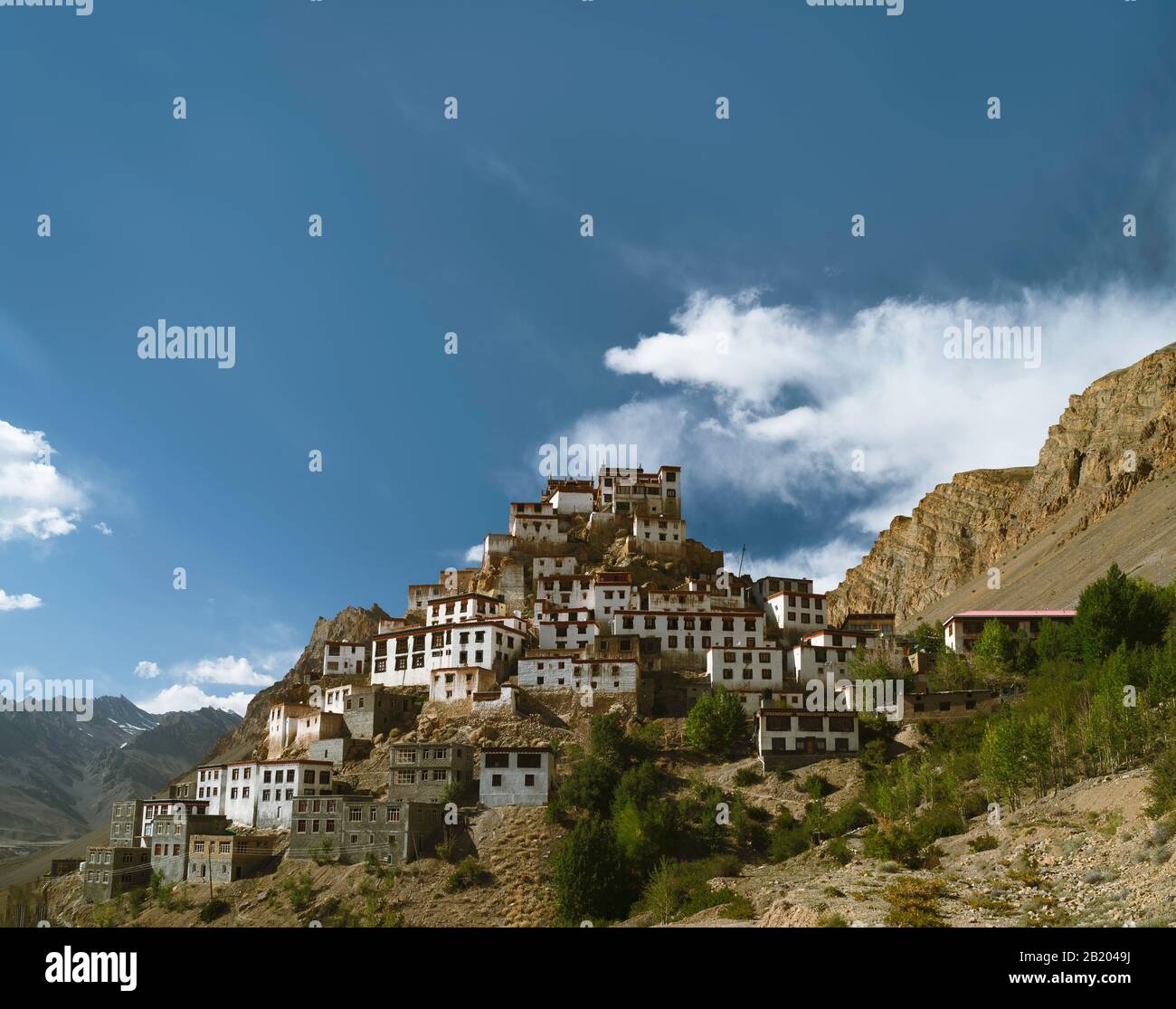 Ancient Key monastery flanked by the Himalayas deep in river valley on bright summer day near Kaza, Himachal Pradesh, India. Stock Photo