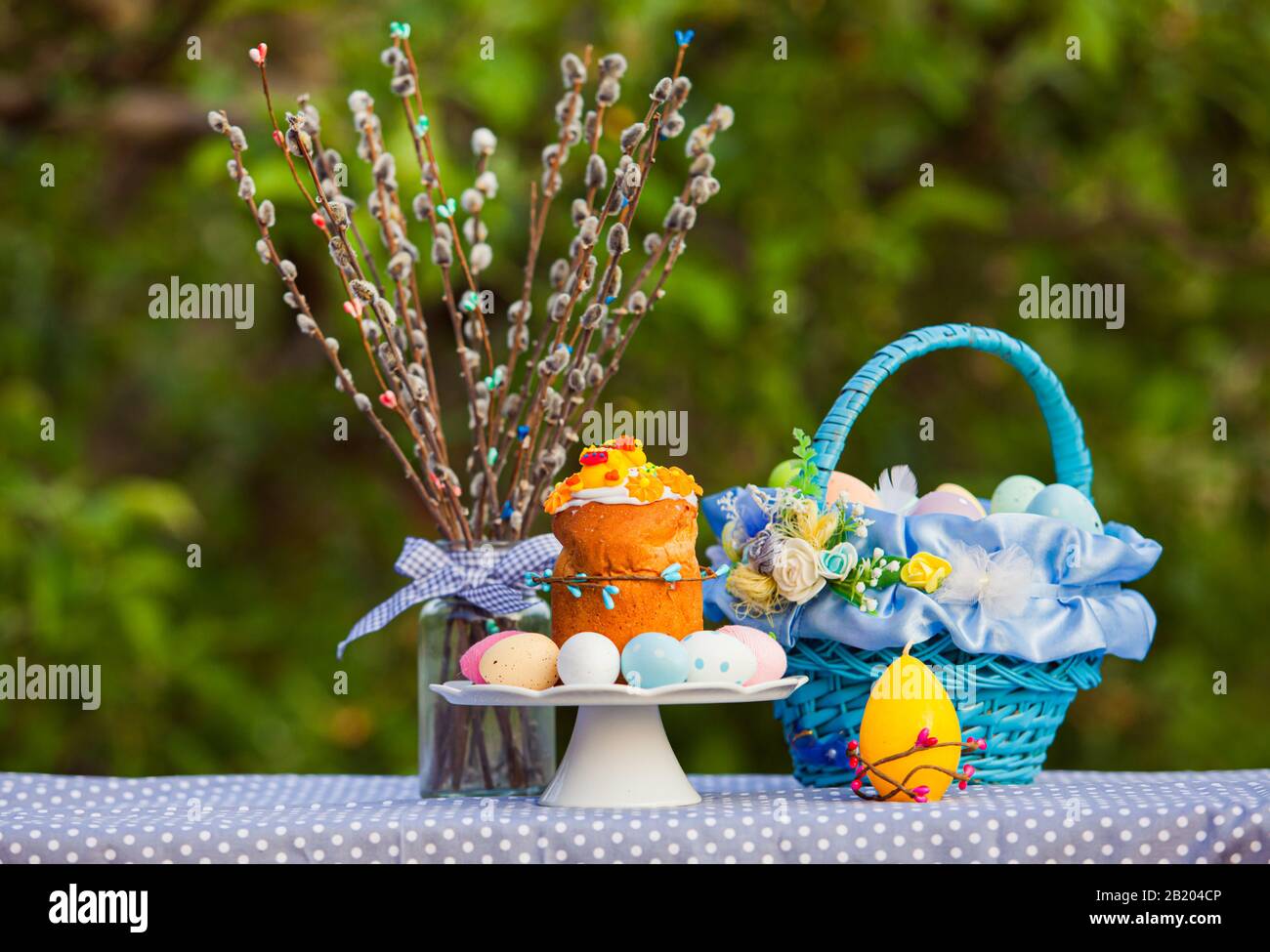Easter cake, willow and painted eggs outdoors Stock Photo
