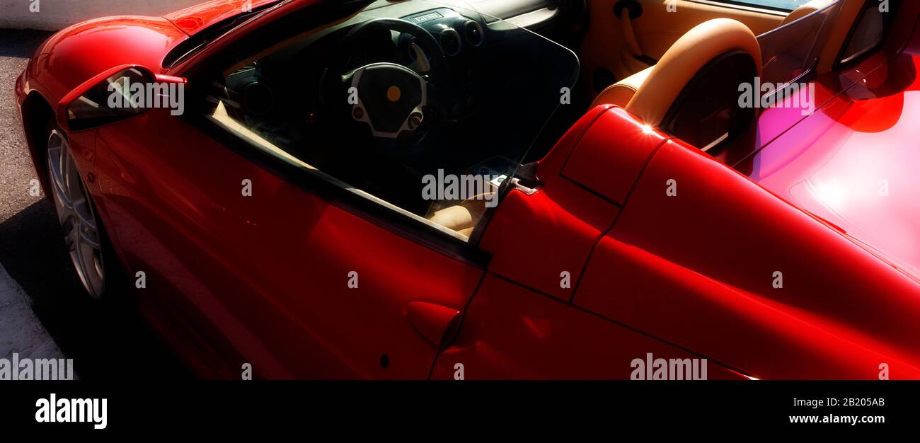 A red supercar (sports car) parked in the sunshine Stock Photo