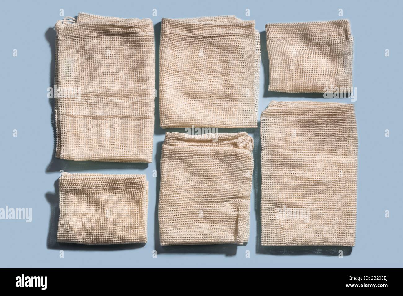 Reusable mesh bags for grocery shopping, pattern on blue background