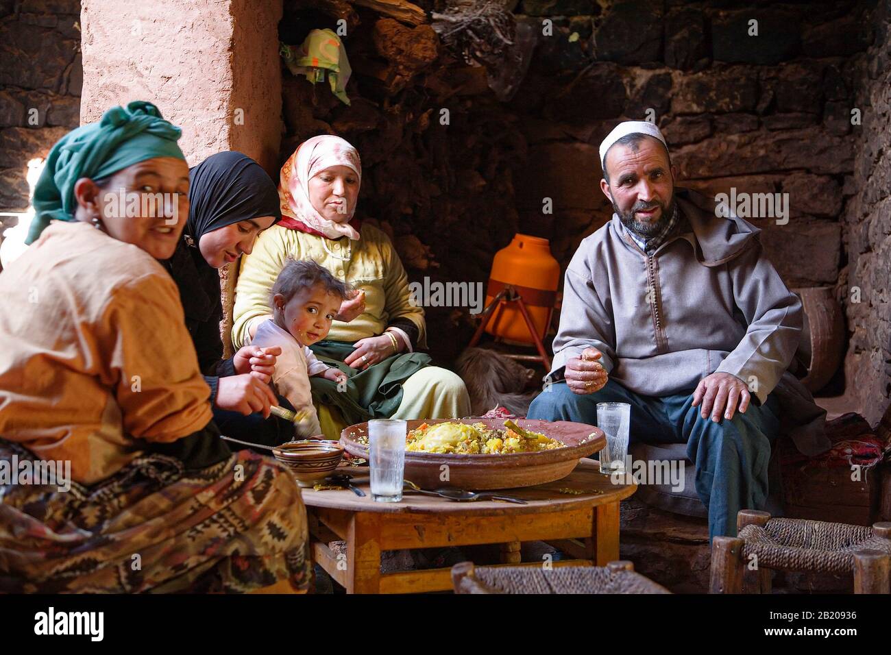 MARRAKECH, MOROCCO - March 09, 2007. A Berber family eat a traditional tagine meal in a Moroccan house near Marrakech, Morocco Stock Photo
