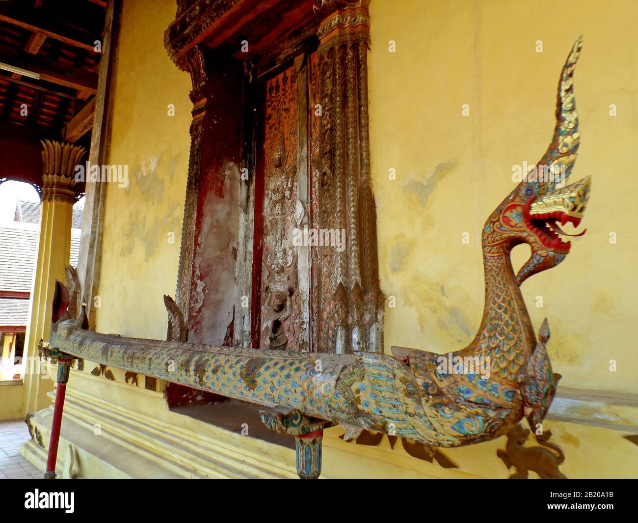 Beautiful old wood carving window of Wat Si Saket temple with Naga  sculpture in foreground, Vientiane, Laos Stock Photo - Alamy