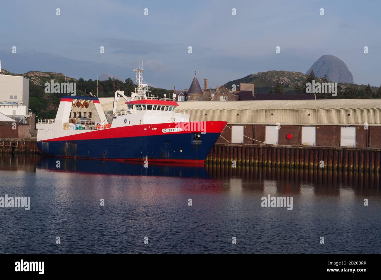 A large deep sea fishing ship moored in Lochinver harbour, Scotland Stock Photo