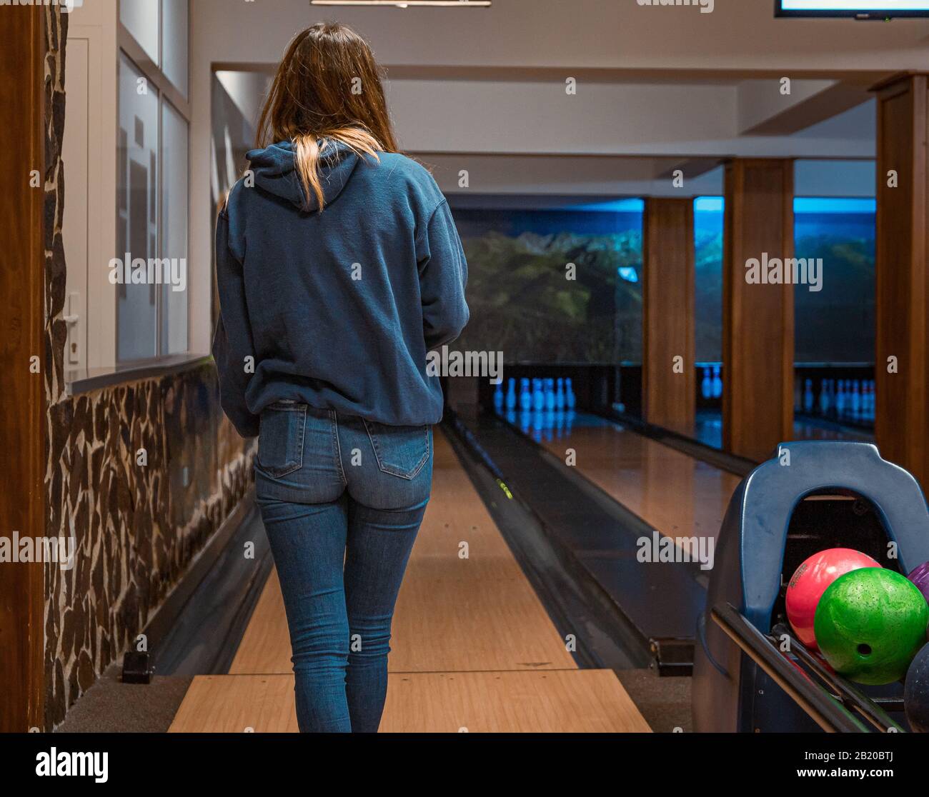 Woman at bowling alley with bowling ball hires stock photography and