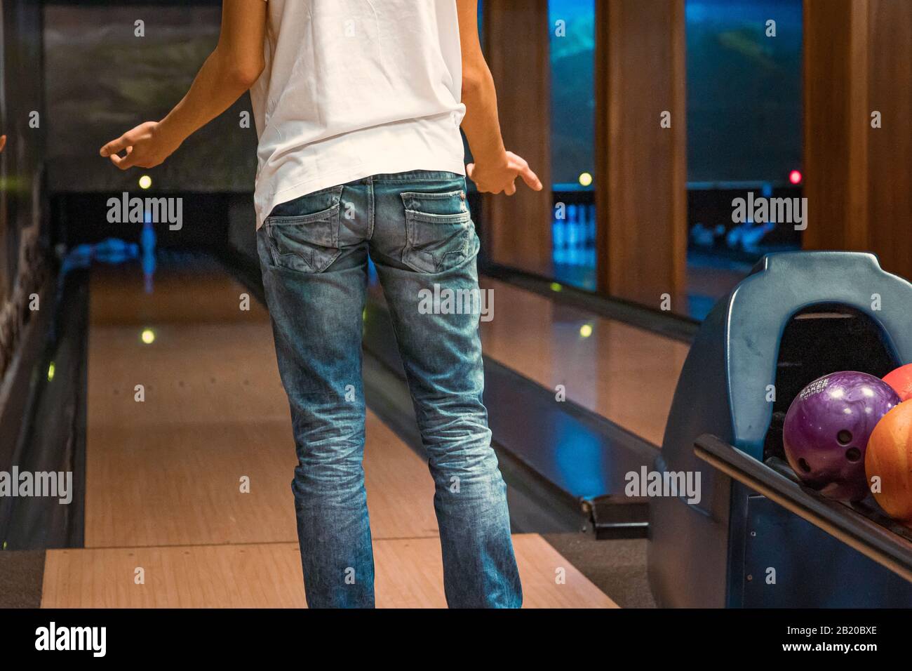 Young man being angry over bad throw with bowling ball Stock Photo Alamy