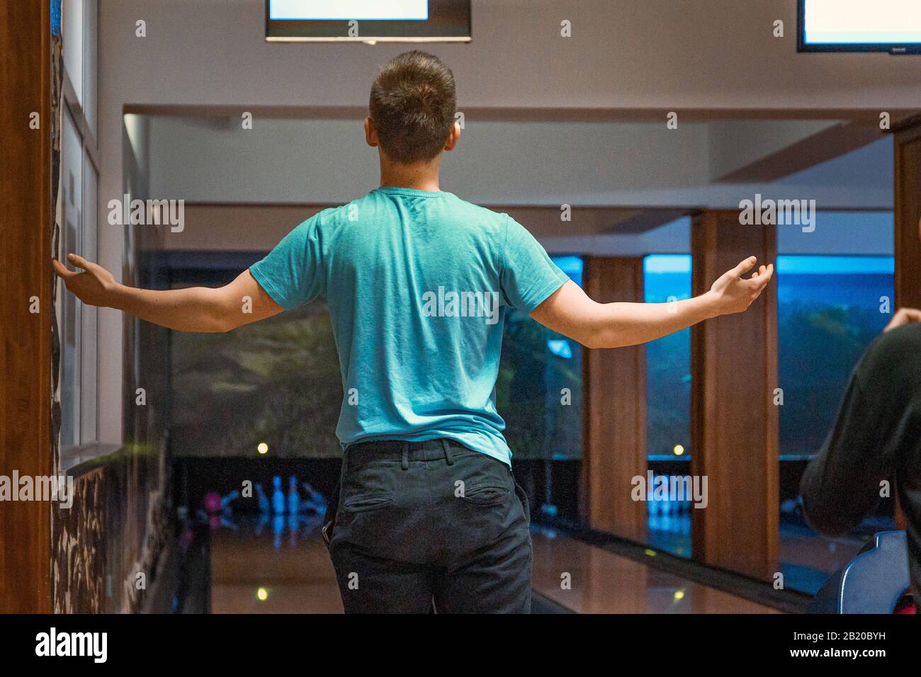 Young man being angry over bad throw with bowling ball Stock Photo Alamy