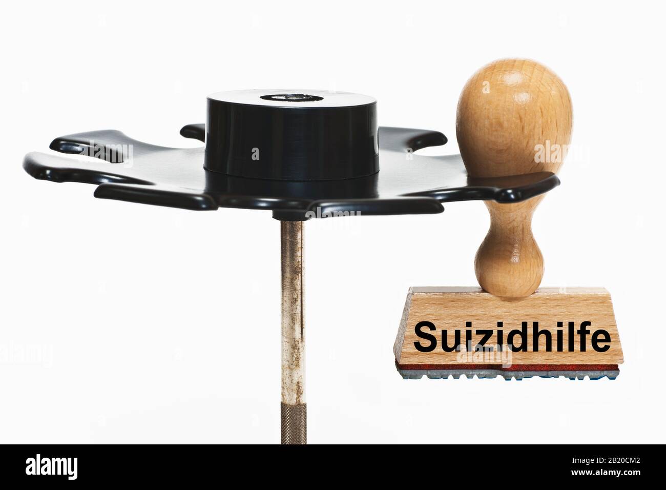a stamp with the inscription Suizidhilfe (Medically assisted suicide) hangs in a stamp rack Stock Photo