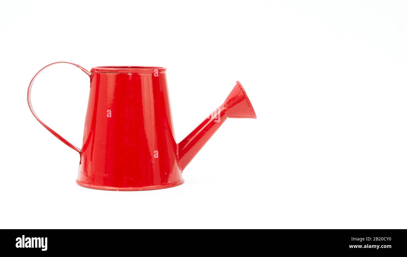 Red watering can on white background Stock Photo - Alamy