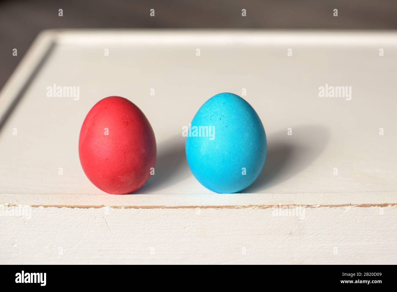 Two Easter eggs in a row- blue and red Stock Photo