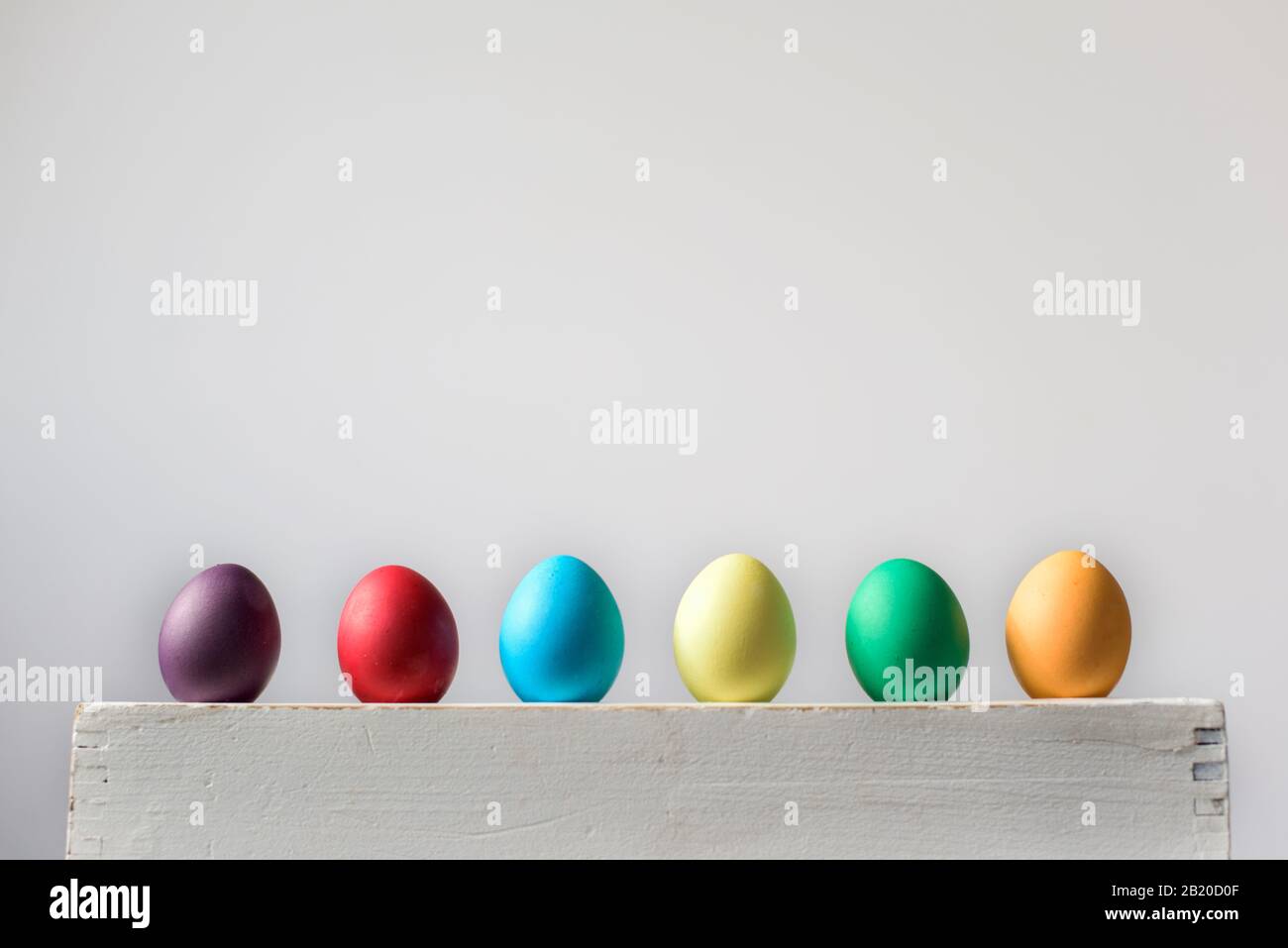 Six Easter hen eggs in different colors in a row Stock Photo