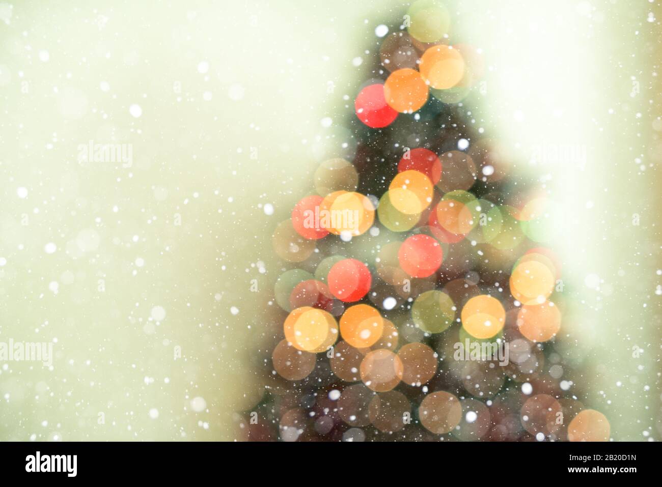 Bokeh christmas tree background with snowfall - defocused lights Stock Photo